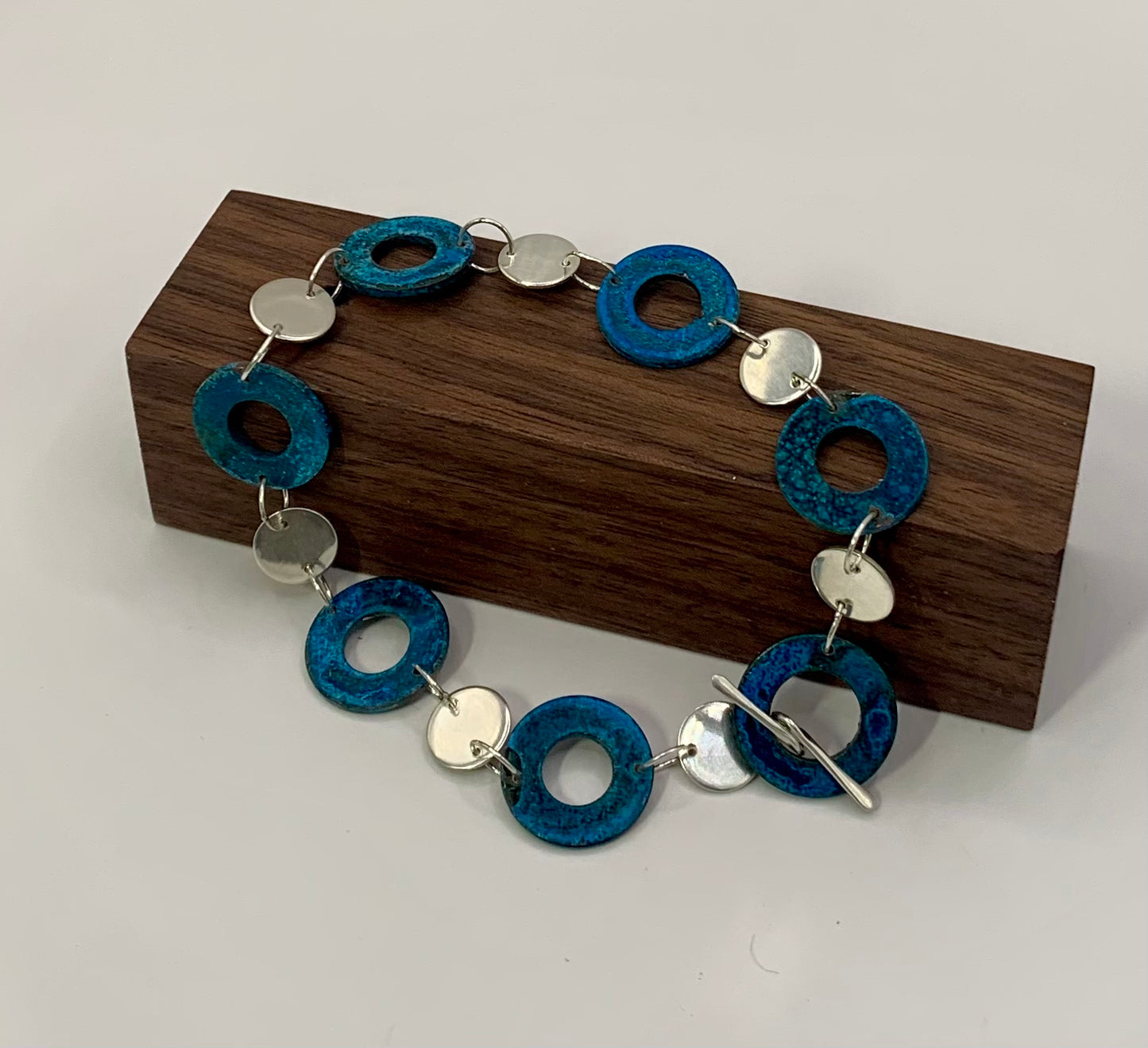 Stunning blue patina'd reclaimed copper washers accented with recycled sterling silver to create this beautiful bracelet.  